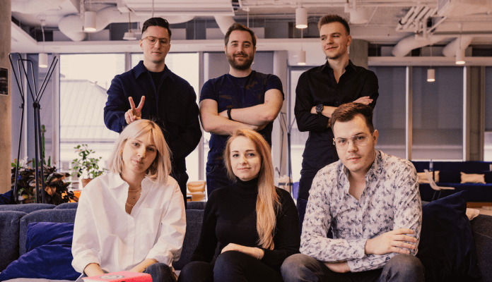 Group photo, three people sitting on the couch, three standing behind them.