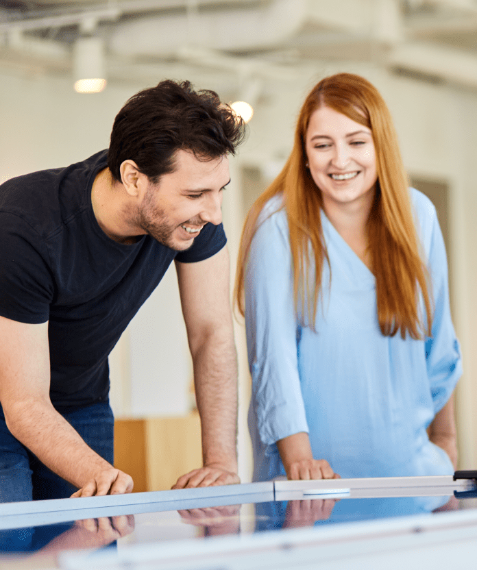 A woman and a man exchanging views on information from the meeting.